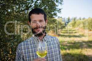 Portrait of man standing with a glass of wine
