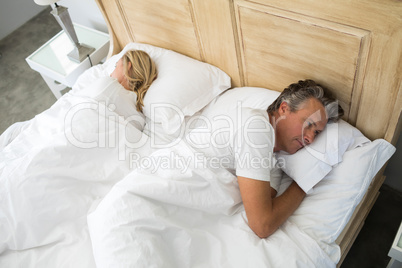 Couple lying on bed after having an argument