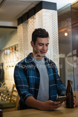 Man using mobile phone at bar