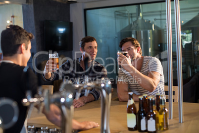 Friends enjoying beer at bar