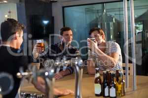 Friends enjoying beer at bar