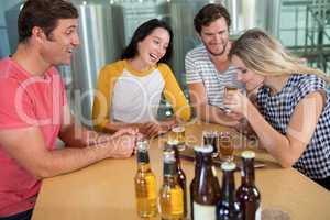 Happy friends enjoying beer at bar