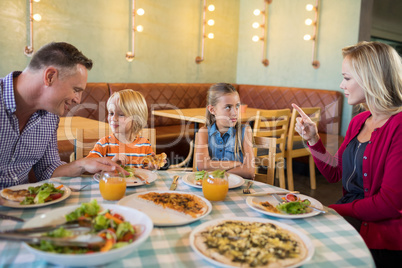 Parents talking to children in restaurant