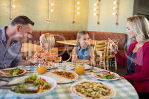 Parents talking to children in restaurant