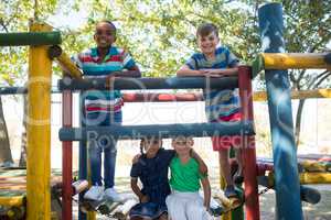 Happy friends on enjoying on jungle gym at playground
