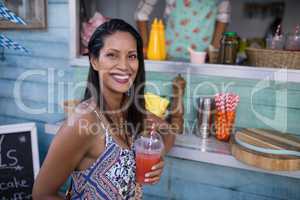 Portrait of beautiful woman having juice at counter