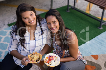 Happy friends having snacks