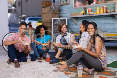 Friends interacting while having snacks and juice