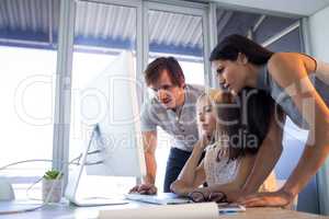 Executives discussing over computer during a meeting