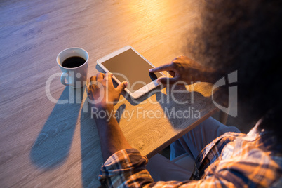 Male executive using digital tablet at his desk