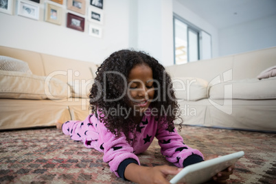 Girl using digital tablet in the living room