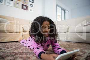 Girl using digital tablet in the living room
