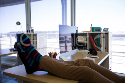 Male executive relaxing at his desk