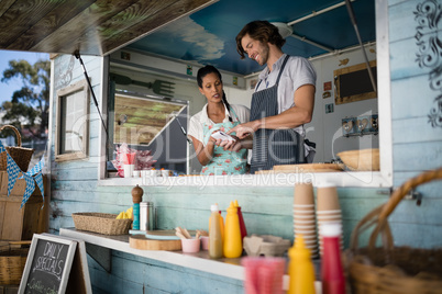 Waiter and waitress interacting with each other