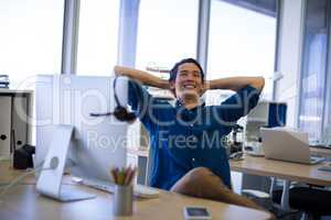 Male executive relaxing at his desk