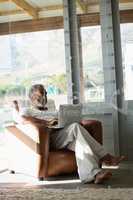 Senior man using laptop at home