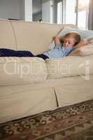 Boy sleeping on sofa in the living room