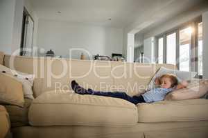 Boy sleeping on sofa in the living room