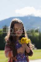 Cute girl holding bunch of fresh flower