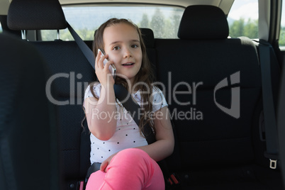 Portrait of cute girl talking on mobile phone