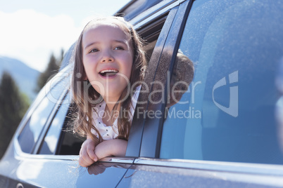 Cute girl looking out of the car window