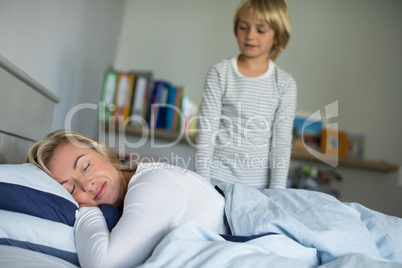 Mother sleeping on bed in the bedroom