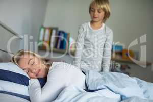 Mother sleeping on bed in the bedroom