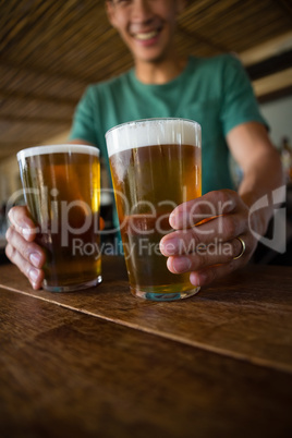 Male bartender serving beer