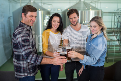 Happy friends toasting beer