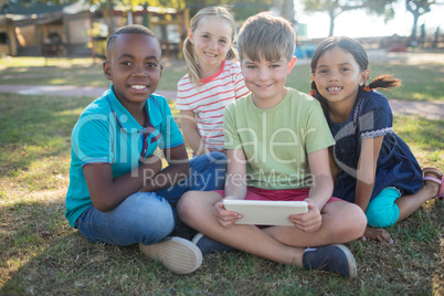 Portrait of smiling children sitting at park
