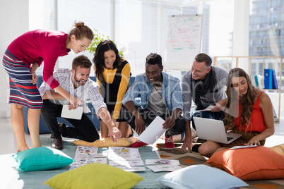 Business colleagues discussing over document