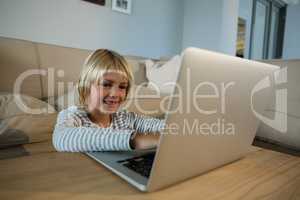 Boy using laptop in the living room