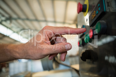 Hand pressing a control button