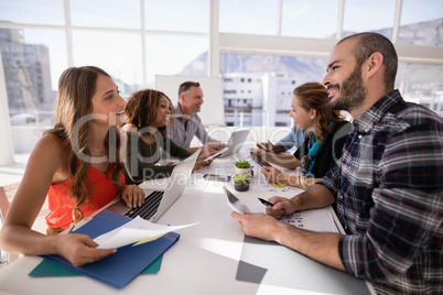 Executives interacting with each other during meeting