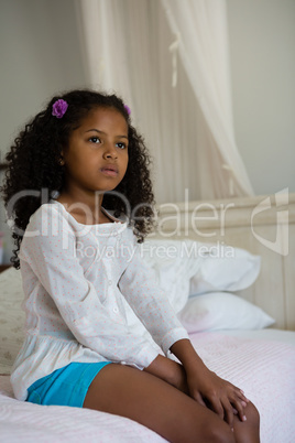 Girl sitting on bed in the bedroom at home