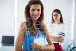 Female executive holding digital tablet in office