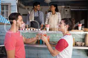 Couple toasting a glasses of juice at counter
