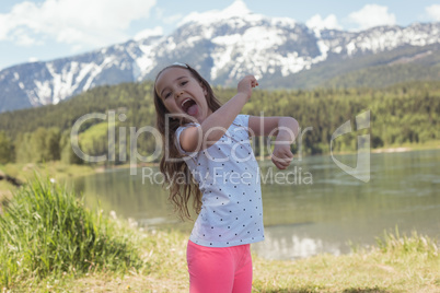 Portrait of cute girl having fun near river