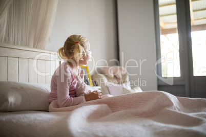 Girl relaxing on bed in the bedroom at home