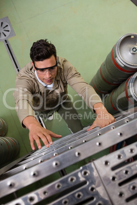 High angle view of worker climbing ladder at brewery