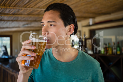 Thoughtful man drinking beer