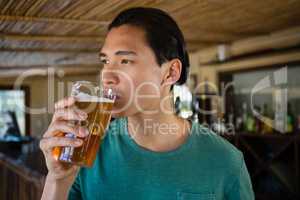 Thoughtful man drinking beer