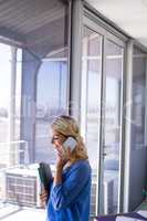 Female executive talking on mobile phone