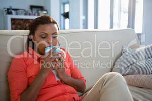 Woman having coffee in the living room