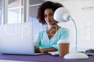 Female executive working over laptop