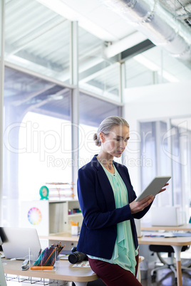 Female executive using digital tablet at her desk Female executive using digital tablet at her desk
