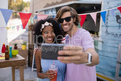 Happy couple taking selfie from mobile phone