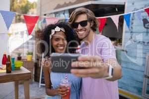 Happy couple taking selfie from mobile phone