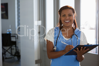 Doctor writing on clipboard in the hospital