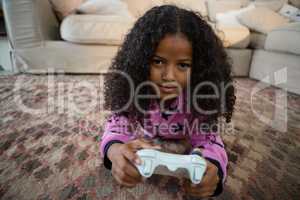 Girl playing video game in the living room at home